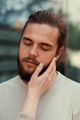 Young bearded man with closed eyes enjoying. Female hand with blue nails caressing face. Lifestyle Young bearded man with closed eyes enjoying. Female hand with blue nails caressing face. Lifestyle - PhotoDune Item for Sale