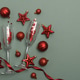 Champagne Flutes and Red Christmas Decorations on Green Background Champagne Flutes and Red Christmas Decorations on Green Background - PhotoDune Item for Sale