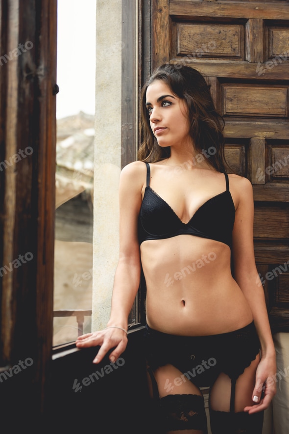 Sexy young woman in lingerie posing near a window Stock Photo by javi_indy Sexy young woman in lingerie posing near a window Stock Photo by javi_indy