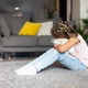 Young girl sitting on carpet hugging stuffed animal in living room Young girl sitting on carpet hugging stuffed animal in living room - PhotoDune Item for Sale
