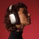 Profile portrait of a woman wearing headphones on red background. Profile portrait of a woman wearing headphones on red background. - PhotoDune Item for Sale