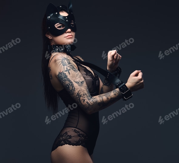 Sexy woman wearing black lingerie in BDSM cat leather mask and accessories posing on dark Stock Photo by fxquadro Sexy woman wearing black lingerie in BDSM cat leather mask and accessories posing on dark Stock Photo by fxquadro