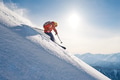 skier rides freeride on powder snow down slope against the backd skier rides freeride on powder snow down slope against the backd - PhotoDune Item for Sale