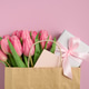 Gift Bag with Pink Tulips and Gift Box on Pink Background. Valentines or Mothers Day Celebration Gift Bag with Pink Tulips and Gift Box on Pink Background. Valentines or Mothers Day Celebration - PhotoDune Item for Sale