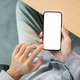 Blank screen smartphone holding with both hand while sitting at wooden table in a cafe or classroom. Blank screen smartphone holding with both hand while sitting at wooden table in a cafe or classroom. - PhotoDune Item for Sale