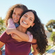 Portrait of happy multiethnic woman giving a piggyback ride to her daughter Portrait of happy multiethnic woman giving a piggyback ride to her daughter - PhotoDune Item for Sale