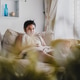 A young boy sitting on the couch while watching the movie A young boy sitting on the couch while watching the movie - PhotoDune Item for Sale
