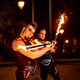 Fire dancers performing with burning staffs at night Fire dancers performing with burning staffs at night - PhotoDune Item for Sale