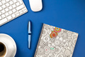 Blue office desk with notebook, pen, keyboard, mouse and a coffee Blue office desk with notebook, pen, keyboard, mouse and a coffee - PhotoDune Item for Sale