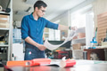 Man exploring printed paper in typography Man exploring printed paper in typography - PhotoDune Item for Sale