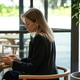 Relaxed businesswoman using smartphone while sitting at cafe table on lunch break from work. Relaxed businesswoman using smartphone while sitting at cafe table on lunch break from work. - PhotoDune Item for Sale