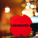 Red Reserved Sign On Wooden Table With Bokeh Background Red Reserved Sign On Wooden Table With Bokeh Background - PhotoDune Item for Sale