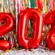 Red foil balloons forming number 2026 with colorful party decorations Red foil balloons forming number 2026 with colorful party decorations - PhotoDune Item for Sale
