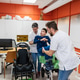 Therapists helping boy with disability for orthotics Therapists helping boy with disability for orthotics - PhotoDune Item for Sale