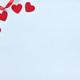 Red gift box with ribbon and felt hearts on a pastel blue background Red gift box with ribbon and felt hearts on a pastel blue background - PhotoDune Item for Sale