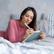 woman lies in bed writes in diary, writes emotions, wish list notebook. female writer plans workday. woman lies in bed writes in diary, writes emotions, wish list notebook. female writer plans workday. - PhotoDune Item for Sale