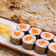 Fresh sushi rolls served with pickled ginger on a rustic countertop Fresh sushi rolls served with pickled ginger on a rustic countertop - PhotoDune Item for Sale