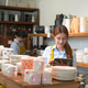 Young woman using tablet in a pottery shop surrounded by ceramic dishes and vases Young woman using tablet in a pottery shop surrounded by ceramic dishes and vases - PhotoDune Item for Sale