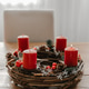 First candle lit on advent wreath made with branches. Cozy home in winter time. First candle lit on advent wreath made with branches. Cozy home in winter time. - PhotoDune Item for Sale