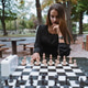 Young woman playing chess Young woman playing chess - PhotoDune Item for Sale