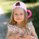 A little girl 3 years old in a pink cap rides a scooter. Summer time. A little girl 3 years old in a pink cap rides a scooter. Summer time. - PhotoDune Item for Sale