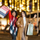 Happy women friends enjoying holiday shopping at night Happy women friends enjoying holiday shopping at night - PhotoDune Item for Sale