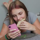 Young Woman Lying on Bed Using Smartphone And Eating Sandwich at Home Young Woman Lying on Bed Using Smartphone And Eating Sandwich at Home - PhotoDune Item for Sale