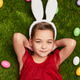 Cute dreamy girl in bunny ears on green meadow Cute dreamy girl in bunny ears on green meadow - PhotoDune Item for Sale