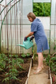 Mature woman with watering can gardening in greenhouse at home - shot in slow motion Mature woman with watering can gardening in greenhouse at home - shot in slow motion - PhotoDune Item for Sale
