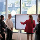 Diverse business team collaborating around a digital whiteboard in a modern office setting Diverse business team collaborating around a digital whiteboard in a modern office setting - PhotoDune Item for Sale