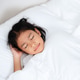 Little girl sleeping peacefully in white bedding Little girl sleeping peacefully in white bedding - PhotoDune Item for Sale