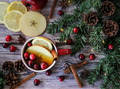 Flat lay Christmas background of hot tea infused with fresh apple lemon cinnamon and cranberries Flat lay Christmas background of hot tea infused with fresh apple lemon cinnamon and cranberries - PhotoDune Item for Sale