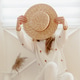 Young woman holding a summer hat in hands in a white room. No face Young woman holding a summer hat in hands in a white room. No face - PhotoDune Item for Sale
