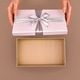 Woman opening empty pink gift box silver ribbon bow Mocha Mousse background Woman opening empty pink gift box silver ribbon bow Mocha Mousse background - PhotoDune Item for Sale