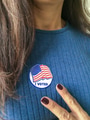 Latino Woman with a I Voted sticker on her chest and victory sign with her fingers on election day Latino Woman with a I Voted sticker on her chest and victory sign with her fingers on election day - PhotoDune Item for Sale