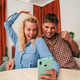 Excited young couple celebrating a joyful moment together using their smartphone to bet online Excited young couple celebrating a joyful moment together using their smartphone to bet online - PhotoDune Item for Sale