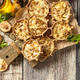 Rustic mushroom tartlets on wooden cutting board perfect for appetizers. Top view flat lay. Rustic mushroom tartlets on wooden cutting board perfect for appetizers. Top view flat lay. - PhotoDune Item for Sale
