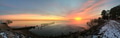 Panoramic enchanting beach view of a pretty sunset after a snowy day during winter time by the water Panoramic enchanting beach view of a pretty sunset after a snowy day during winter time by the water - PhotoDune Item for Sale