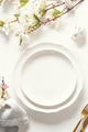 Easter festive dinner with golden eggs, festive tableware and flowers. Easter festive dinner with golden eggs, festive tableware and flowers. - PhotoDune Item for Sale