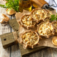 Rustic mushroom tartlets on wooden cutting board perfect for appetizers. Copy space. Rustic mushroom tartlets on wooden cutting board perfect for appetizers. Copy space. - PhotoDune Item for Sale