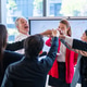 Diverse business team celebrates success with a high five huddle in a modern office meeting room Diverse business team celebrates success with a high five huddle in a modern office meeting room - PhotoDune Item for Sale