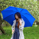 Young woman teenager in park with blue umbrella having moment in nature by Spring floral apple tree Young woman teenager in park with blue umbrella having moment in nature by Spring floral apple tree - PhotoDune Item for Sale