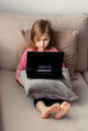 Cute todller girl sitting on couch, using tablet pad laptop gadget, watching cartoons at home Cute todller girl sitting on couch, using tablet pad laptop gadget, watching cartoons at home - PhotoDune Item for Sale