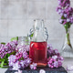 Preparation of syrup from the lilac flowers. Glass jar of homemade lilac syrup and lilac flowers Preparation of syrup from the lilac flowers. Glass jar of homemade lilac syrup and lilac flowers - PhotoDune Item for Sale
