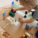 A child plays a homemade game made of cardboard traffic A child plays a homemade game made of cardboard traffic - PhotoDune Item for Sale