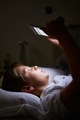Boy Looking At Digital Tablet In Bed At Night Boy Looking At Digital Tablet In Bed At Night - PhotoDune Item for Sale