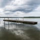 Lake of Soustons reflecting a cloudy sky and wooden docks Lake of Soustons reflecting a cloudy sky and wooden docks - PhotoDune Item for Sale