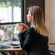 Thoughtful businesswoman enjoying drinking coffee at restaurant after productive day at work. Thoughtful businesswoman enjoying drinking coffee at restaurant after productive day at work. - PhotoDune Item for Sale