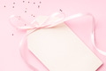 Blank Price Tag with Pink Ribbon Bow on Pink Background. Blank Price Tag with Pink Ribbon Bow on Pink Background. - PhotoDune Item for Sale