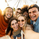 Multiracial group of friends taking selfie with smart mobile phone outside Multiracial group of friends taking selfie with smart mobile phone outside - PhotoDune Item for Sale